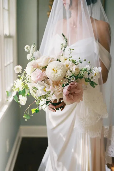 Bridal bouquet, a blush and white bouquet with lush roses, hand-tied in a loose, organic style with soft drape and airy movement