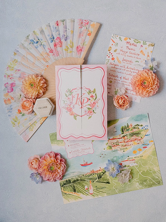 Wedding invitation suite with watercolor wedding invitations, menu and map cards, ring box and blush flowers on light textured fabric surface