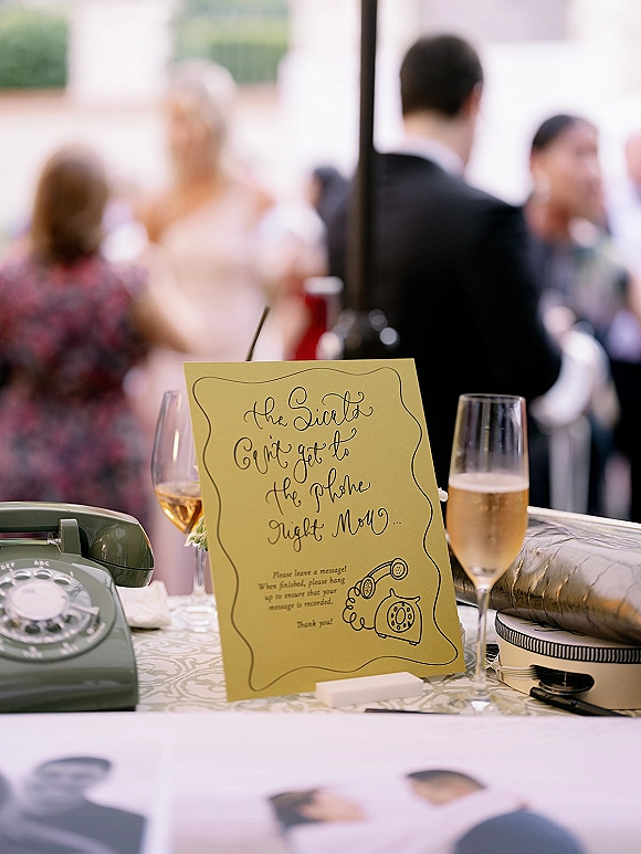 Wedding guestbook phone set as an audio guestbook wedding station with vintage rotary handset, calligraphy sign, and champagne glasses on table