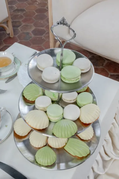 Tiered dessert stand presenting macaron wedding desserts arranged neatly across multiple tiers, ready to serve.