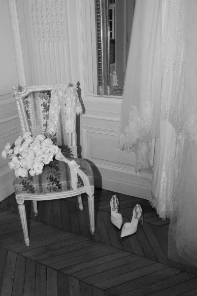 Bridal details and bridal accessories styled with a classic bridal bouquet, set against ornate wall molding and a large mirror.