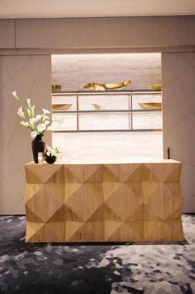 Wedding bar setup with modern wedding bar details, featuring calla lily arrangement in black vases, candles, glassware on backlit shelves