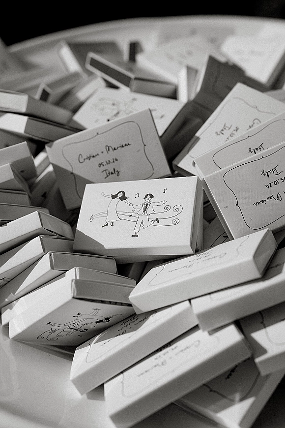 Wedding favors with personalized wedding favors details, featuring favor boxes with handwritten labels and illustrated tags on a tabletop surface