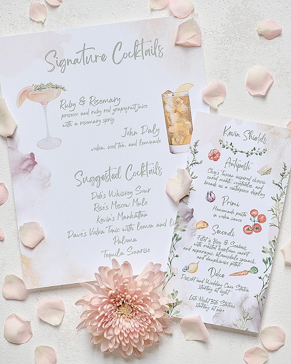 Wedding cocktail menu with signature cocktails sign in calligraphy and watercolor herb illustrations on light linen fabric, with blush flower accent