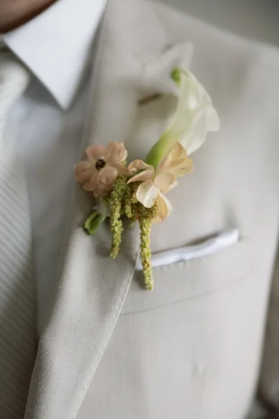 Groom boutonniere styled as a calla lily boutonniere, emphasizing elegant groom details with a clean, timeless look.