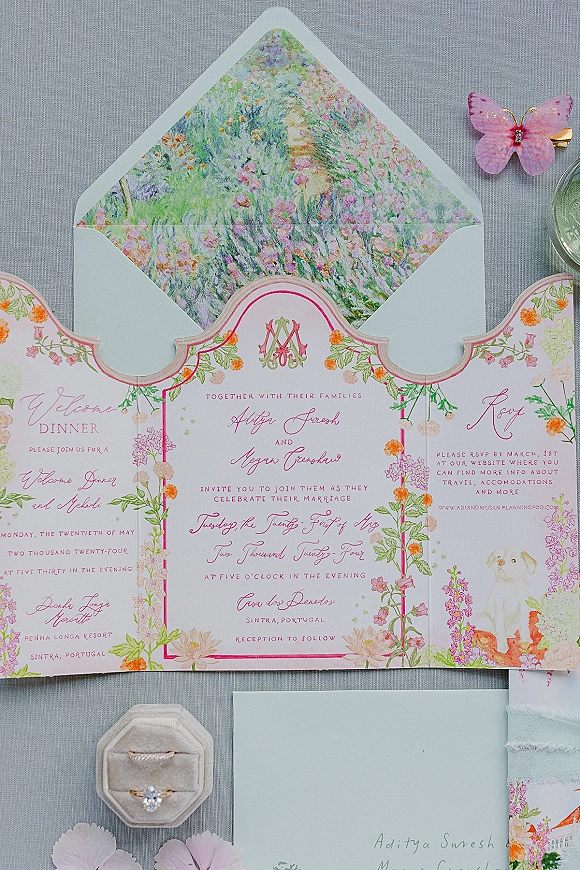 Wedding invitation suite with floral wedding invitations, pink calligraphy and monogram crest on gray linen, with rings and ribbon accent