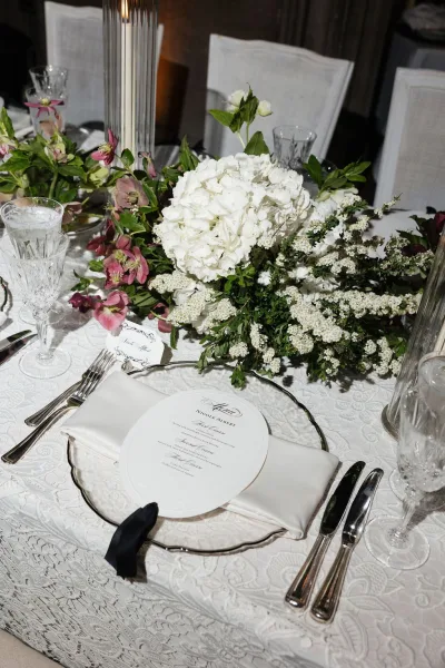 Wedding place setting with a crystal glassware setting arranged for a formal reception, featuring classic detailing and a clean, elegant look.