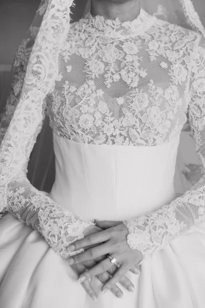 Wedding dress close-up of a lace bridal gown, highlighting long sleeves and delicate texture across the bodice in a refined, elegant style.