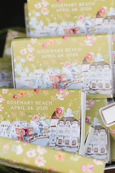 Wedding matchboxes styled as custom matchbox favors, adorned with a delicate floral print and arranged neatly as take-home gifts for guests