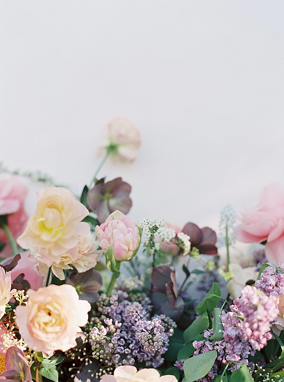 Wedding florals with pastel wedding flowers, featuring pastel roses and lilac blooms with eucalyptus greenery against a clean white backdrop
