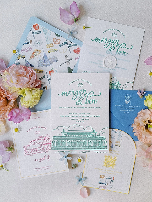 Invitation suite wedding invitation flat lay with envelopes, RSVP and save the date cards, wax seal, petals and QR code on linen fabric