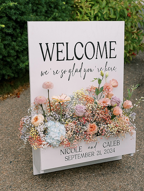 Wedding welcome sign, custom wedding welcome sign with blush roses, hydrangea and baby's breath on a painted wood board by greenery driveway