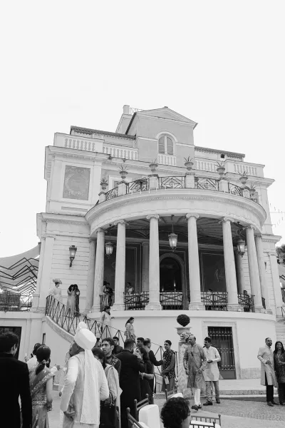 Mansion wedding venue with villa wedding venue elegance, highlighted by towering columns at a grand entrance on a stately historic exterior.