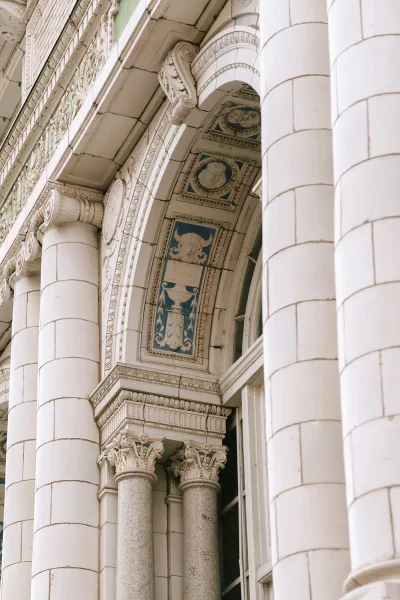 Wedding venue exterior of a historic building facade highlighted by a grand archway and classical symmetry