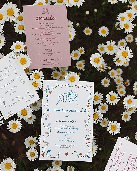 Wedding invitation suite with floral wedding invitations featuring handwritten calligraphy, heart motifs, and illustrated daisy borders on greenery