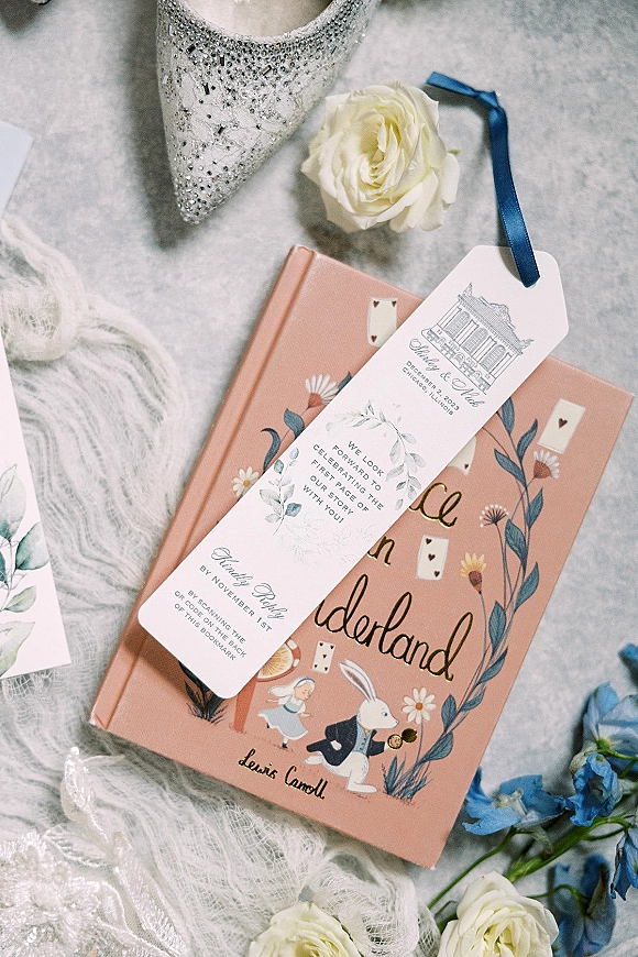 Wedding bookmark custom wedding bookmark favor with blue ribbon, white rose and blue flowers beside a rhinestone bridal shoe on lace tulle flatlay