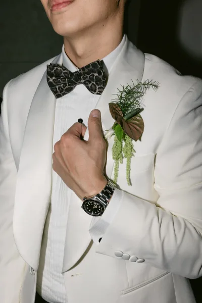 Groom attire on a white dinner jacket groom, styled with a neat bow tie, capturing a clean, modern formal look.