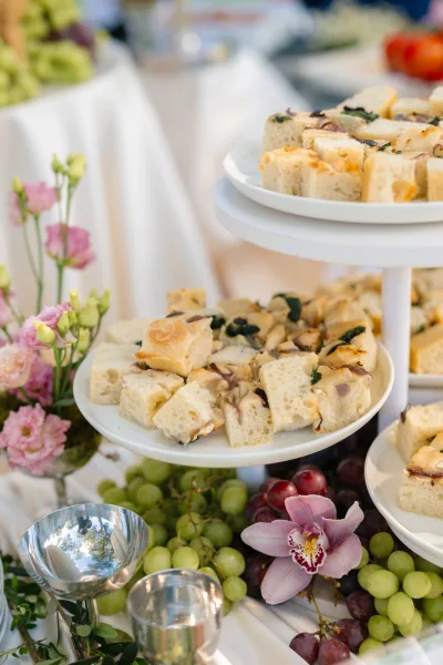 Wedding appetizer display featuring savory focaccia bites artfully arranged for guests during cocktail hour.