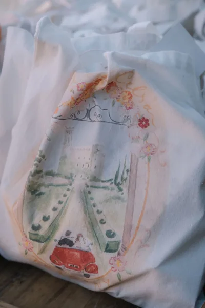 Wedding welcome bag styled as a custom wedding tote, featuring a charming vintage car motif for wedding guests.