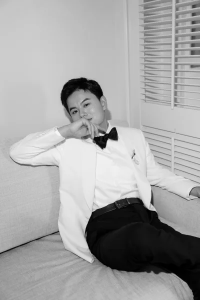 Groom portrait of a tuxedo groom with a classic bow tie, posed indoors with calm poise, crisp lines and clean styling emphasizing modern elegance.