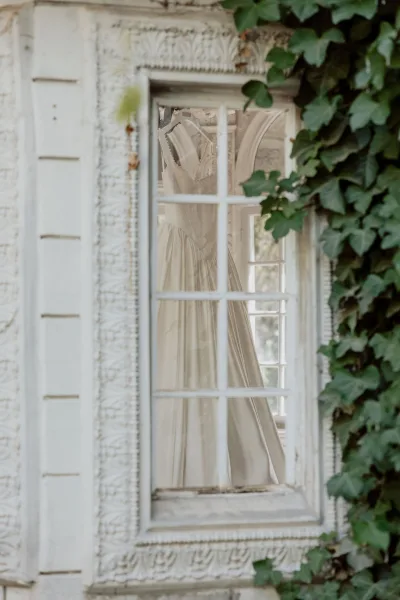 Wedding dress close-up of a bridal gown on hanger, highlighting delicate fabric and elegant tailoring.