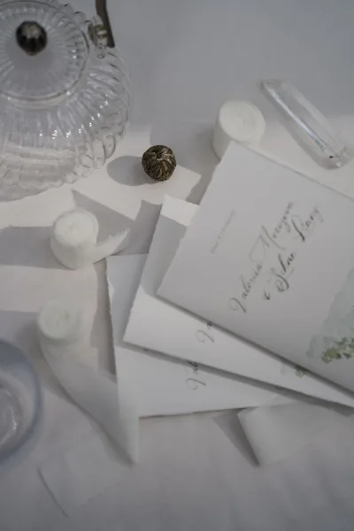 Wedding stationery with a ceremony program artfully arranged, featuring deckle edge paper that conveys a refined, timeless mood.