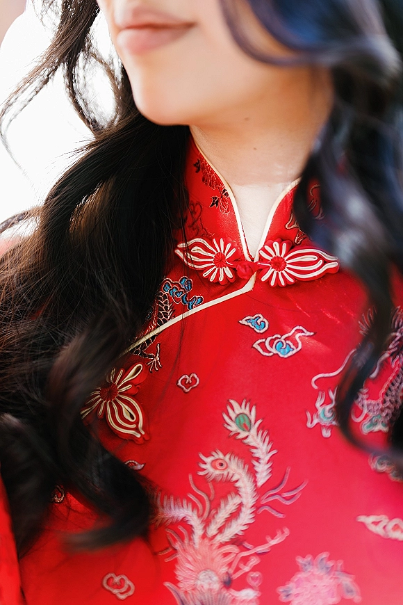Red qipao dress, chinese bridal qipao with embroidered fabric, frog closures and a mandarin collar against a bright neutral background