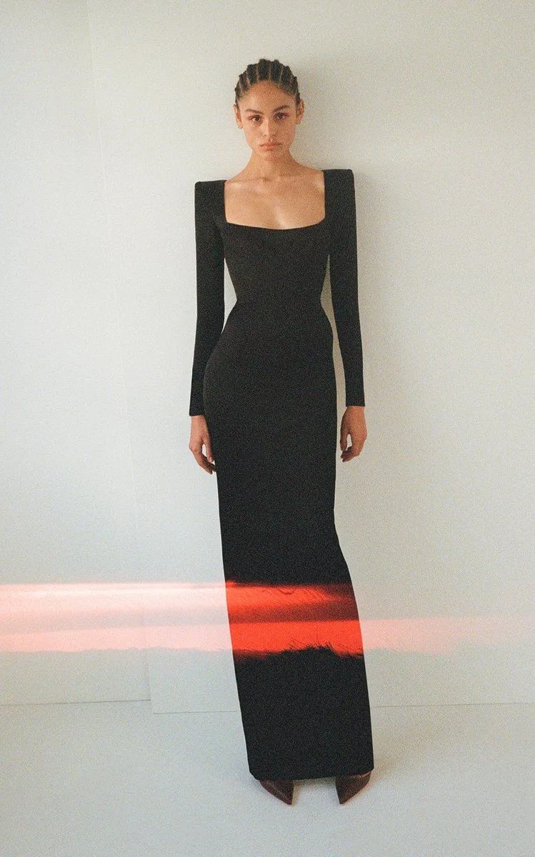 Floor-length black long-sleeve gown with a square neckline