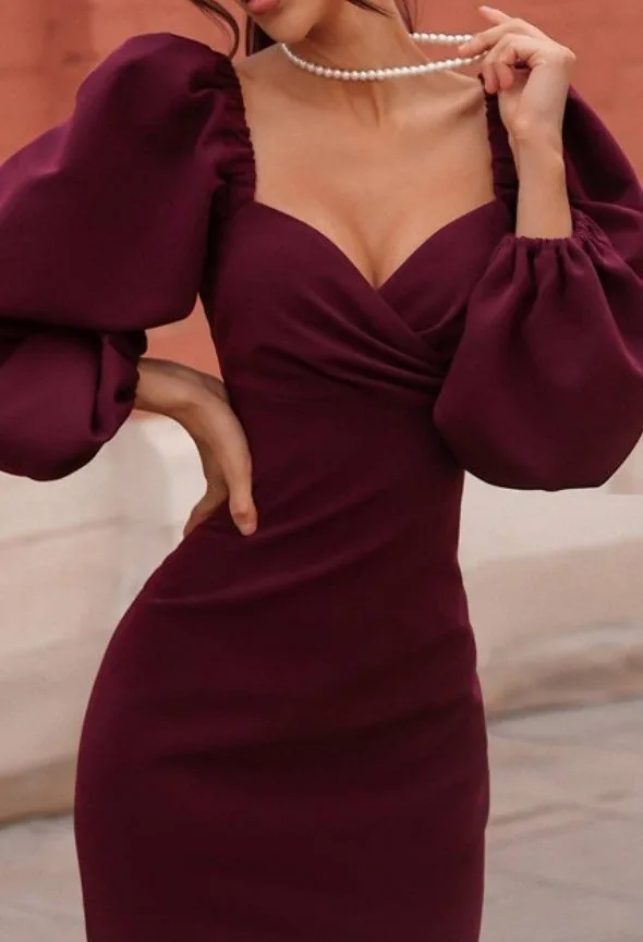 Burgundy wrap dress with dramatic puff sleeves and a pearl necklace