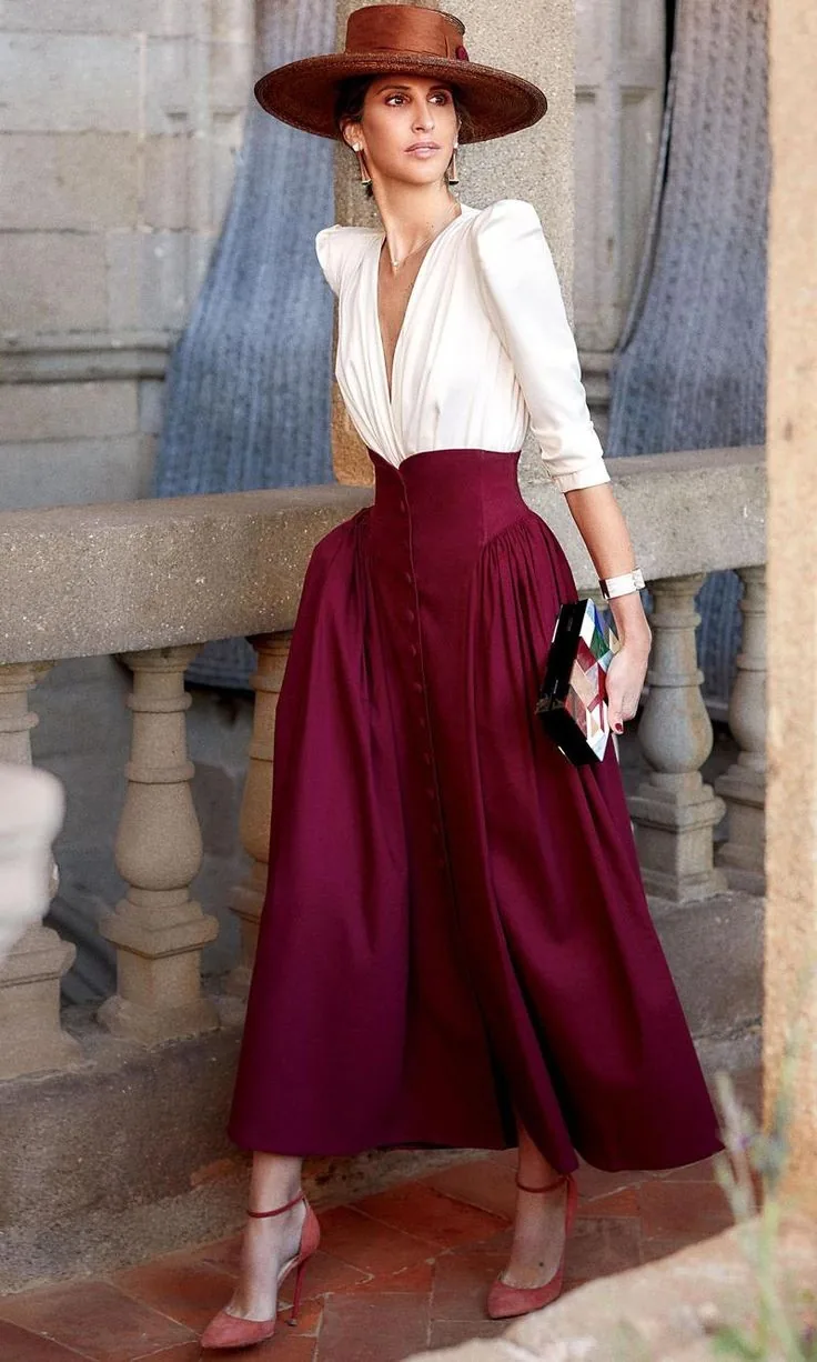 Burgundy high-waisted maxi skirt, white blouse and a rust wide-brim hat