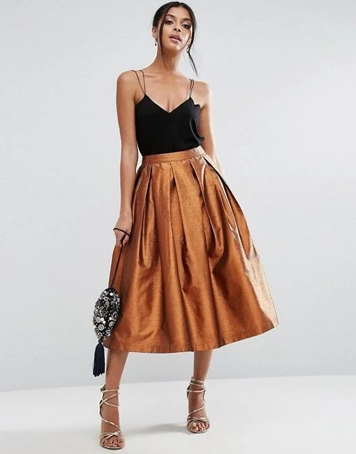 Black camisole with a full copper satin midi skirt and beaded bag