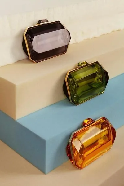 Three faceted jewel-box clutches in smoky quartz, olive and amber resin