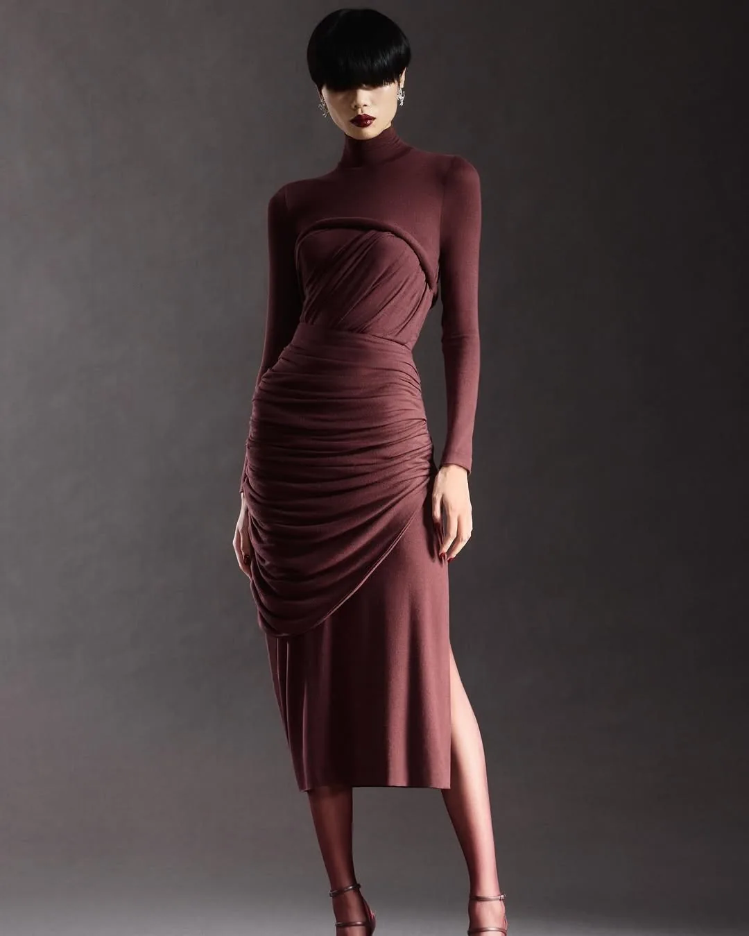 Plum long-sleeve dress with a draped, ruched skirt