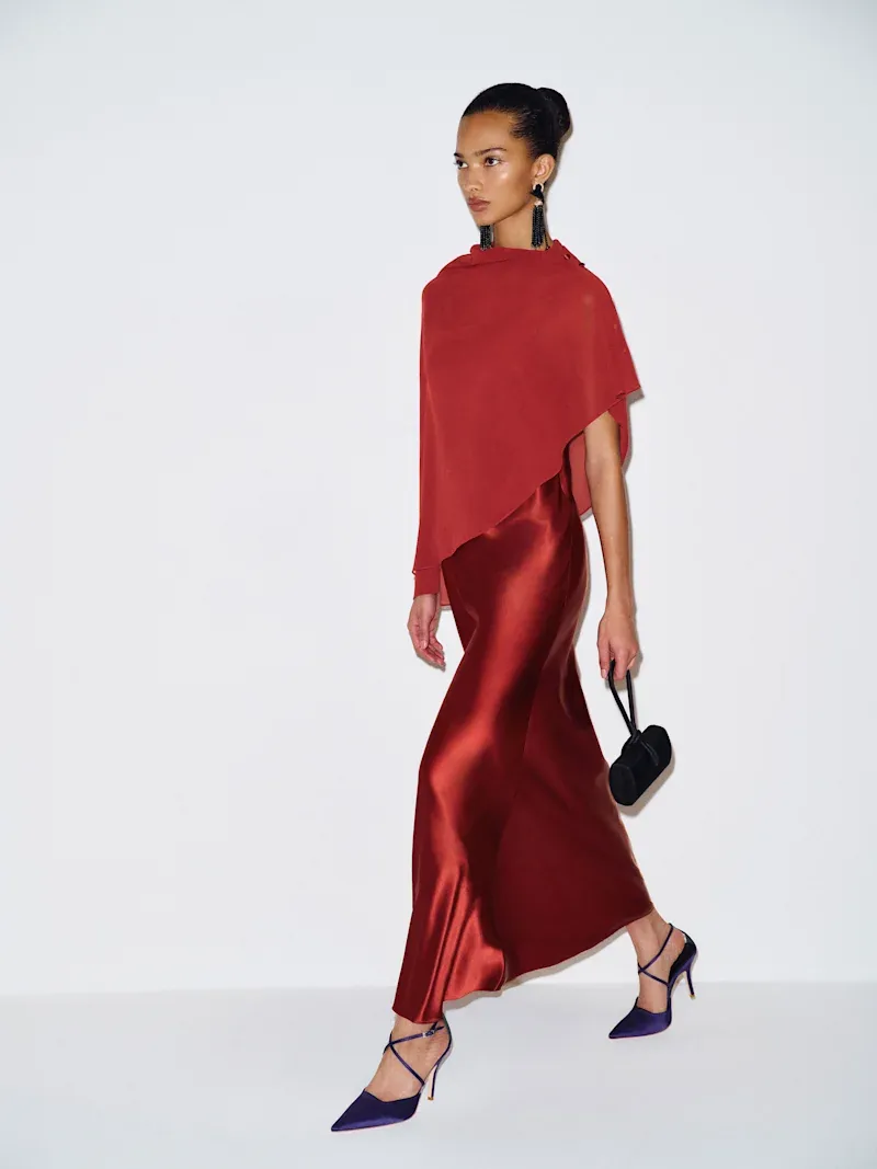 Reformation Lilibeth silk dress in chianti red with a sheer cape falling over the shoulders