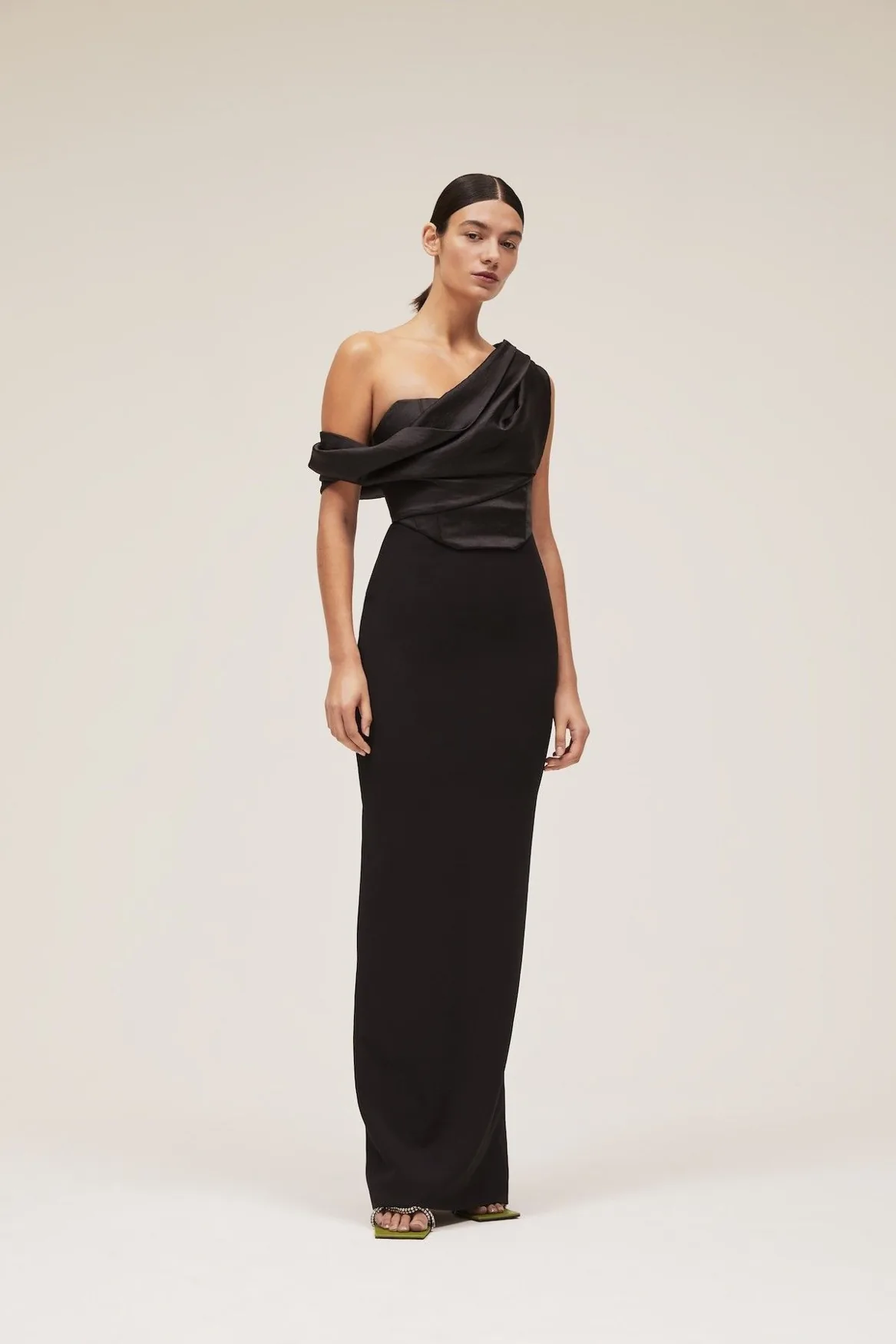 Black column gown with a draped off-the-shoulder neckline