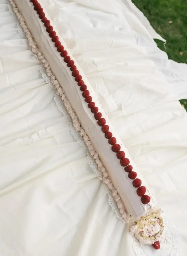 Ruched white tablecloth trimmed with a line of raspberries