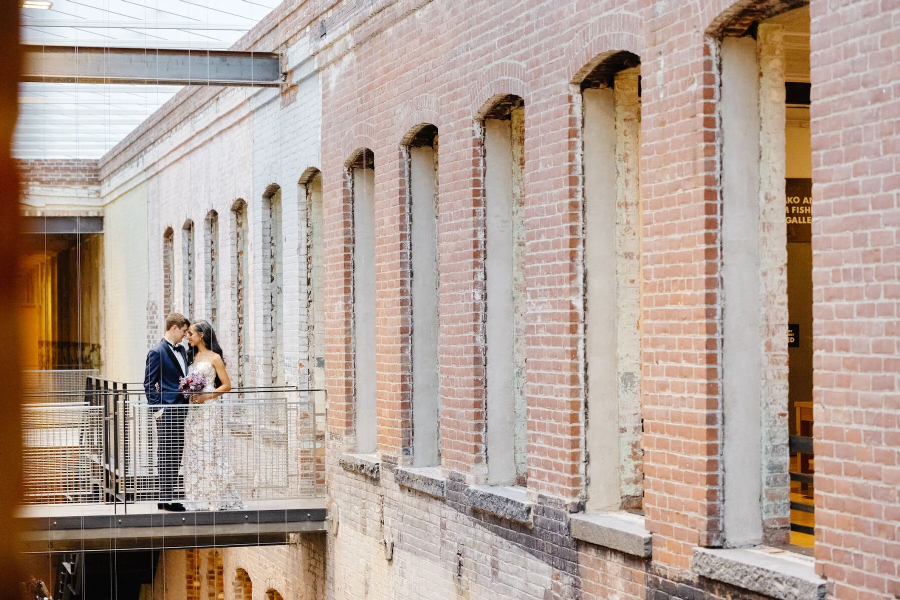 A portrait of a bride and groom between the ceremony and the reception of their art museum wedding, which took place at MASS MoCA.