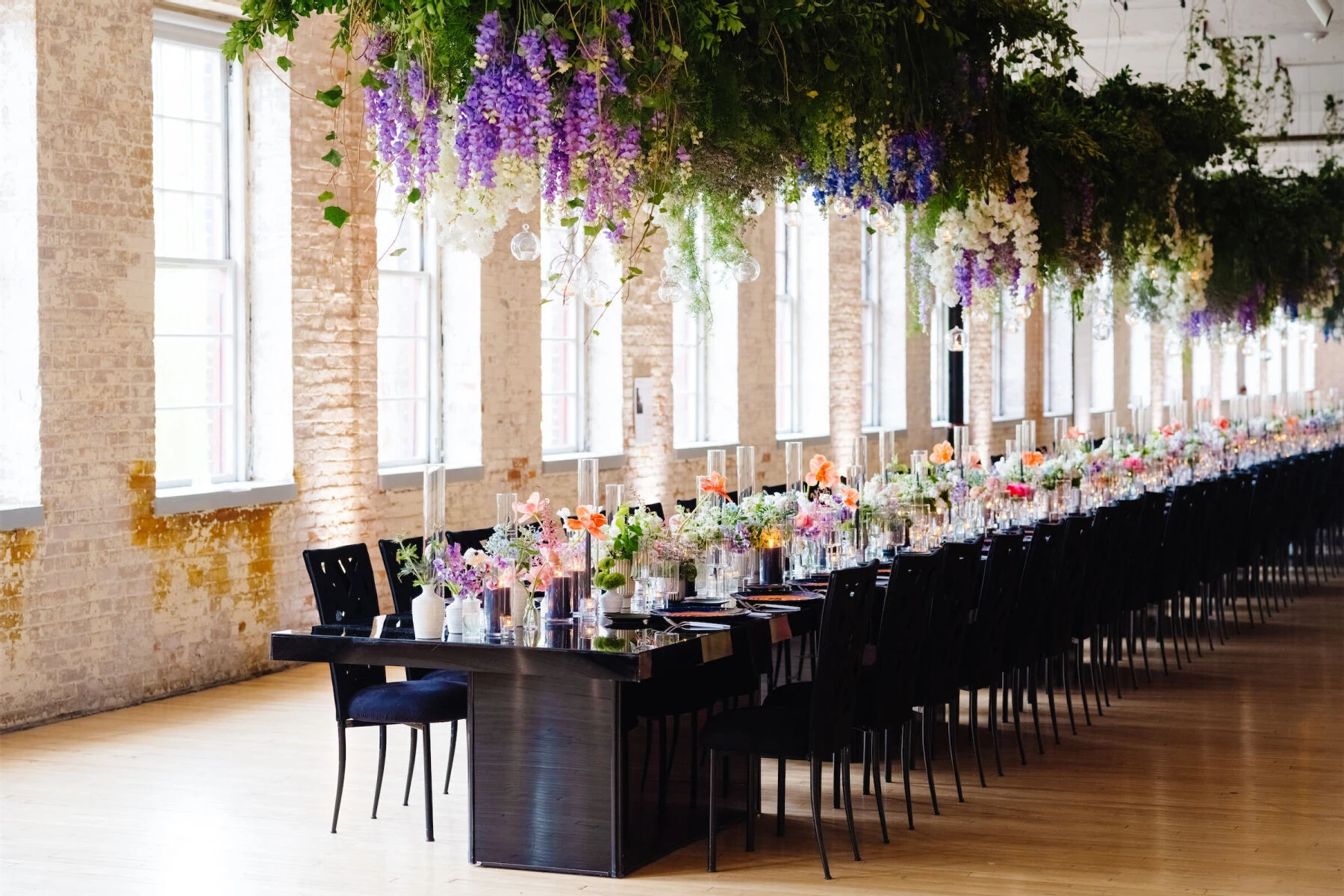 Light shines through the windows of a gallery space where a unique art museum wedding reception transpired. 