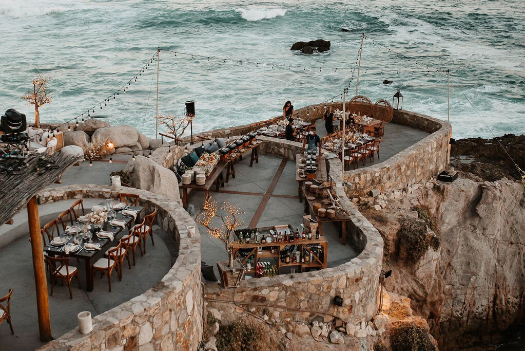 Waterfront boho wedding reception overlooking an oceanside cliff