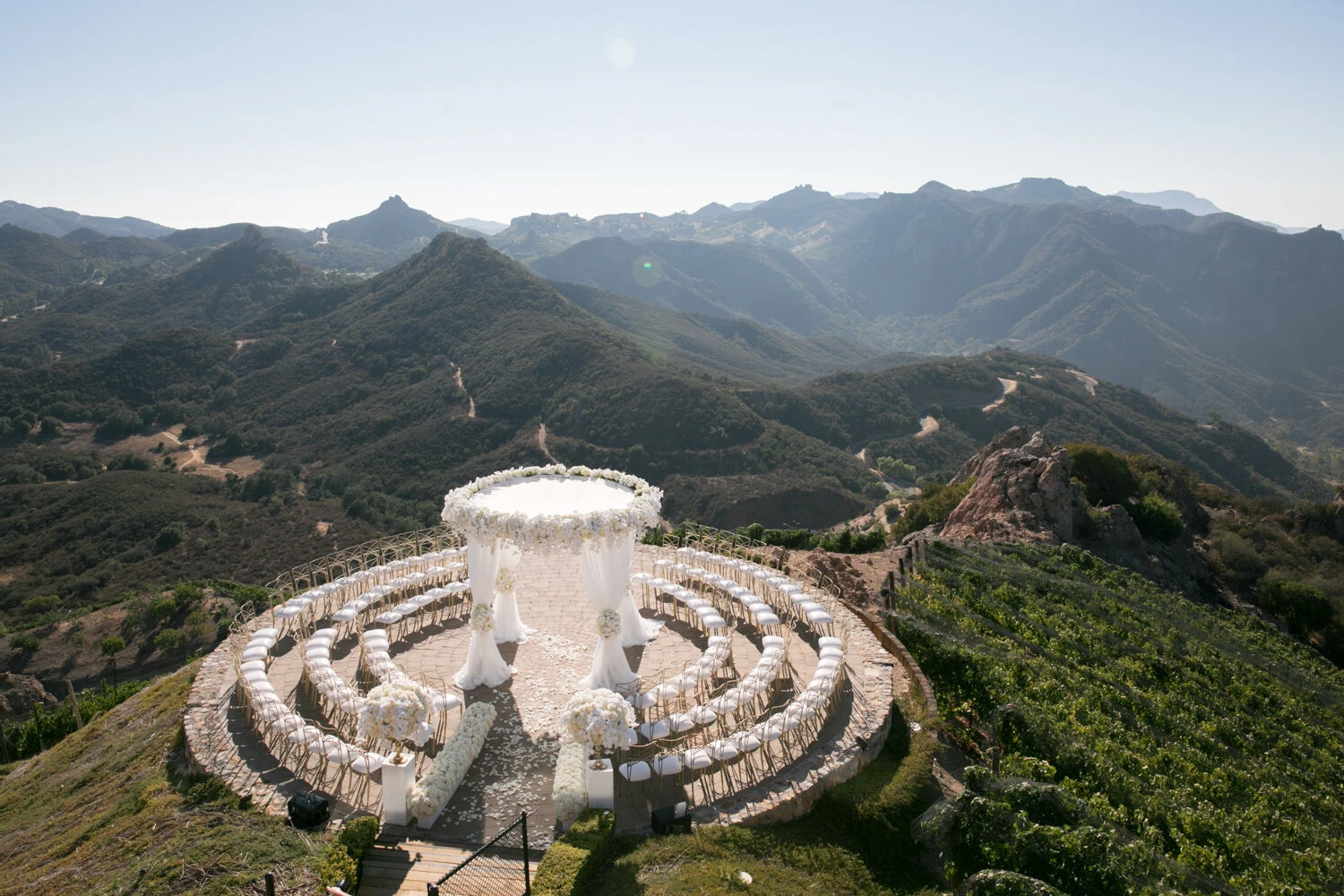 Mountain wedding ceremony set up overlooking a lush green valley