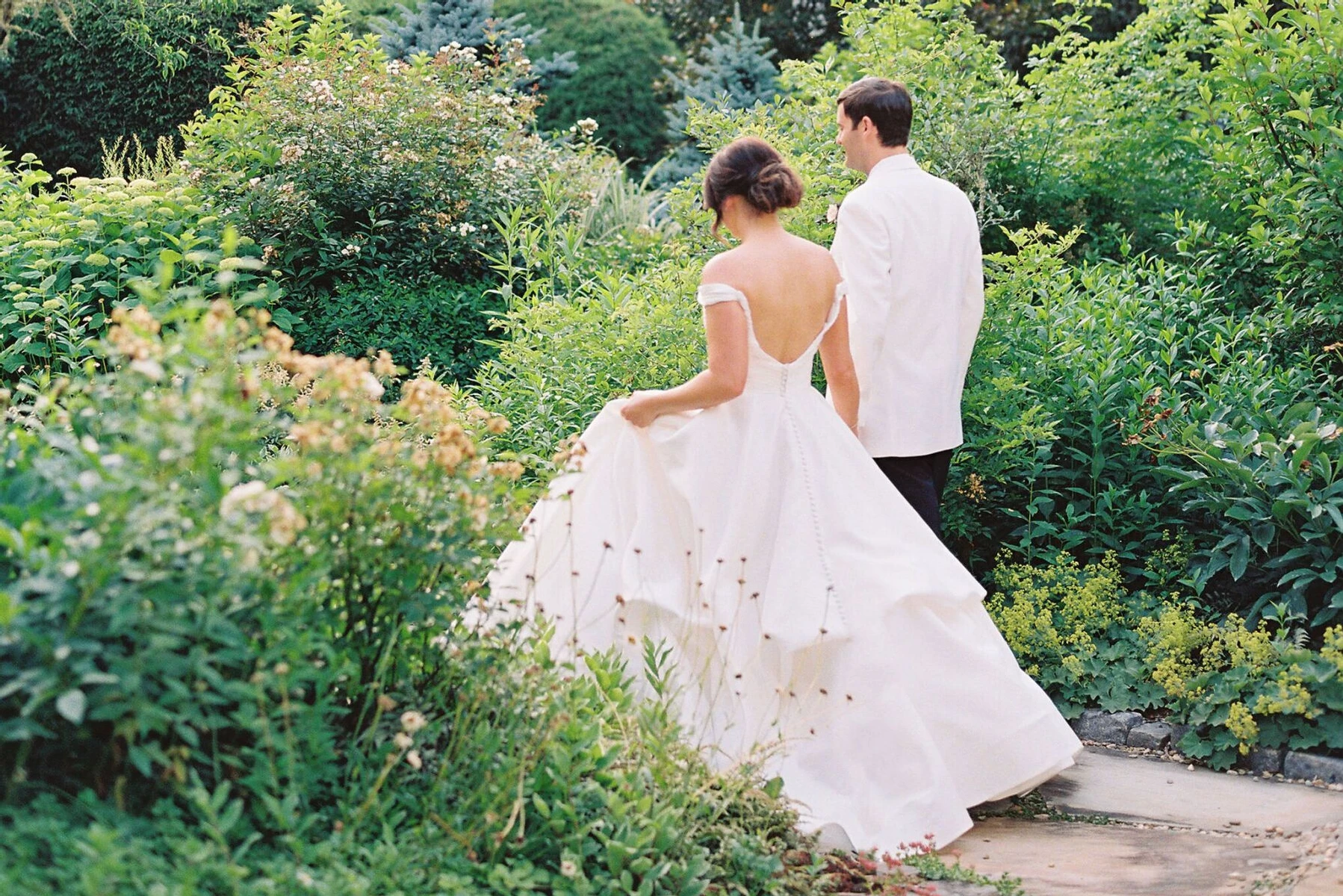 Average Wedding Dress Cost: Classic white wedding dress with full cascading skirt and open back