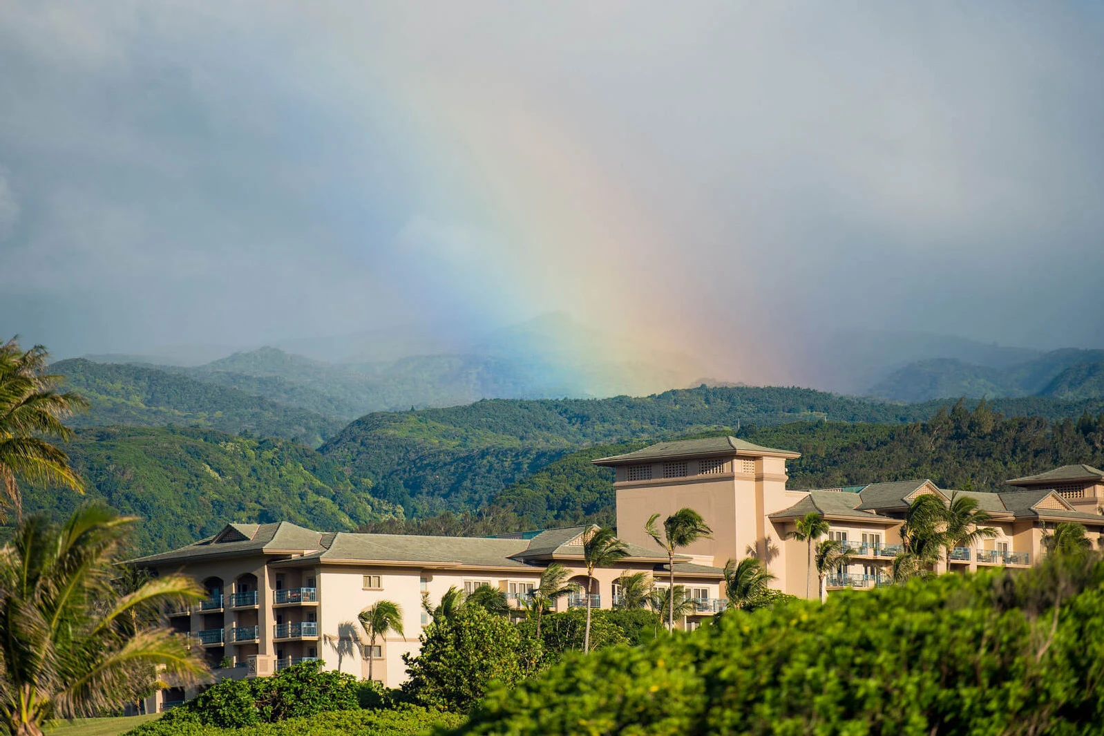 Celebrity Wedding: A resort in Maui with a rainbow overhead and mountains beyond.