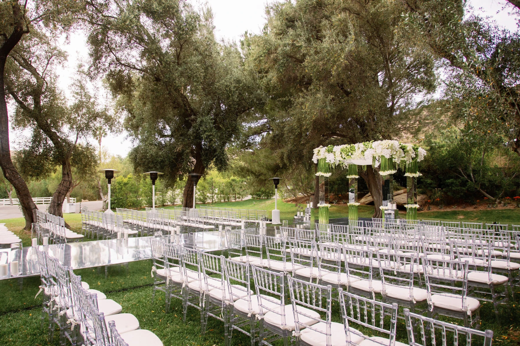 Celebrity Wedding: An outdoor wedding ceremony setup with a raise acrylic aisle in Santa Susana.