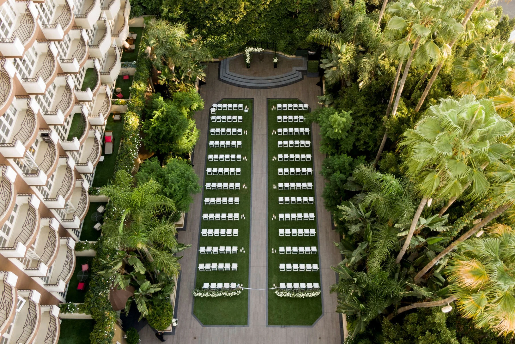 Celebrity Wedding: An overhead view of an outdoor wedding ceremony in a garden area of a resort in LA.