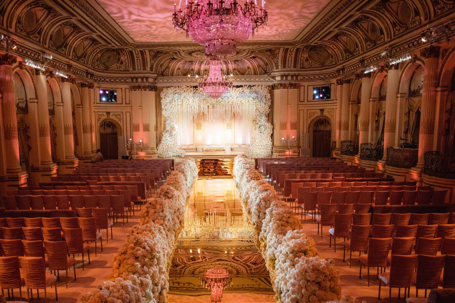 Celebrity Wedding: An indoor ceremony in an opulent ballroom at the Plaza Hotel in New York City.