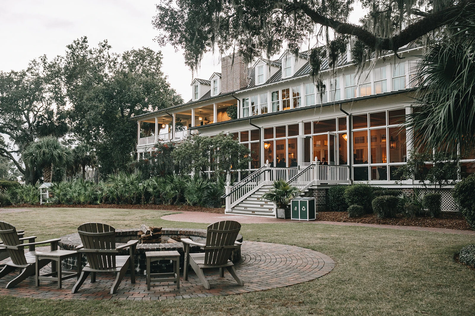 Celebrity Wedding: The outside of a building in Bluffton, South Carolina, with adirondack chairs and large trees.