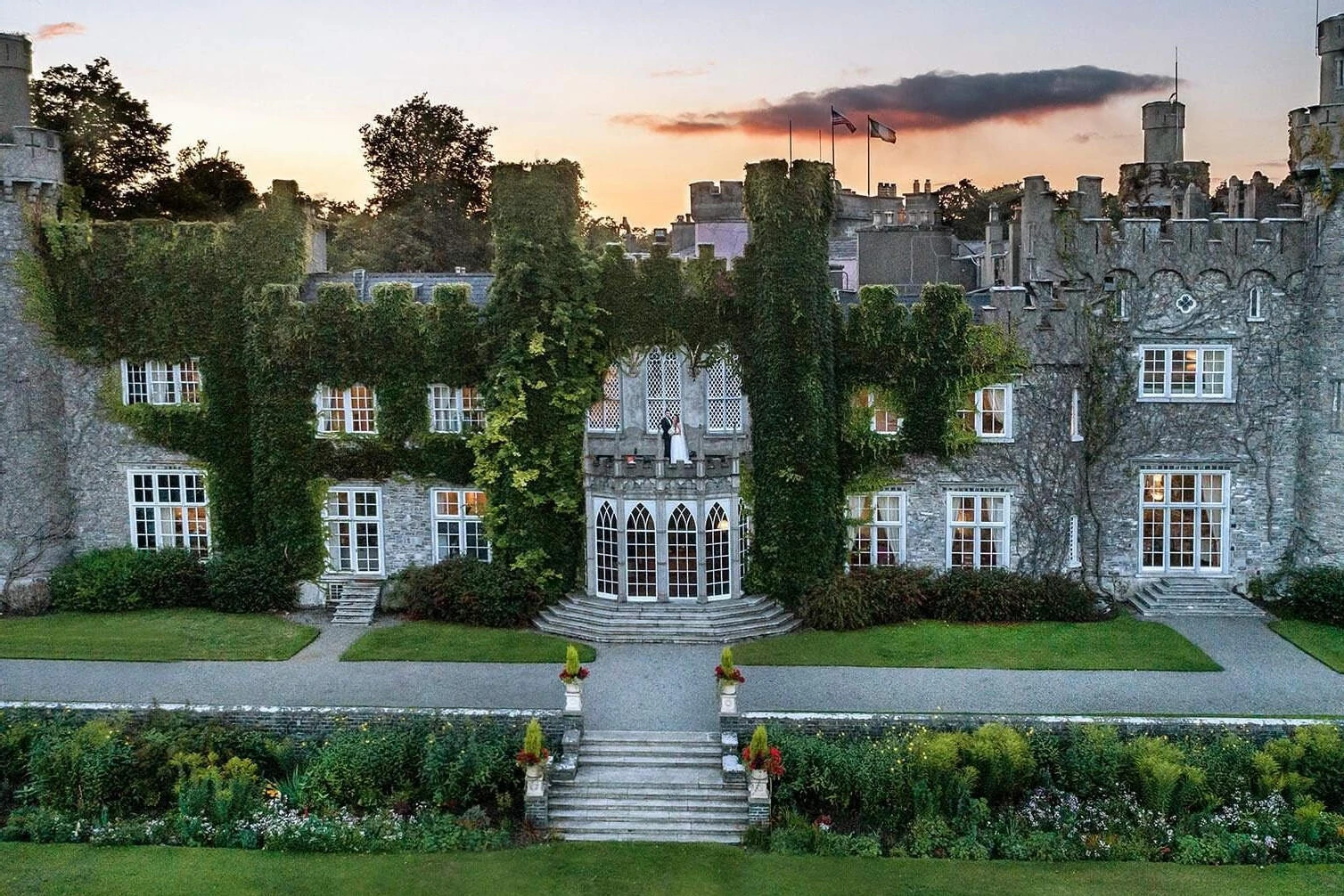 Celebrity Wedding: A castle in Dublin, Ireland at sunset, with ivy growing all over and gardens all around.