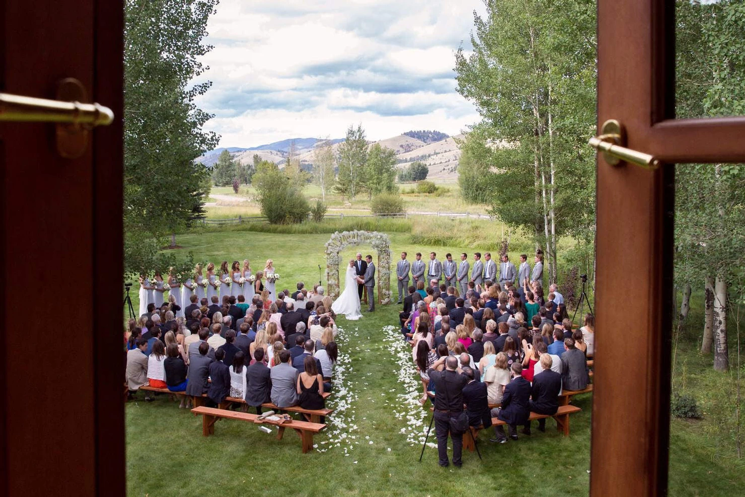 Celebrity Wedding: An outdoor ceremony setup overlooking trees and mountains in Montana.