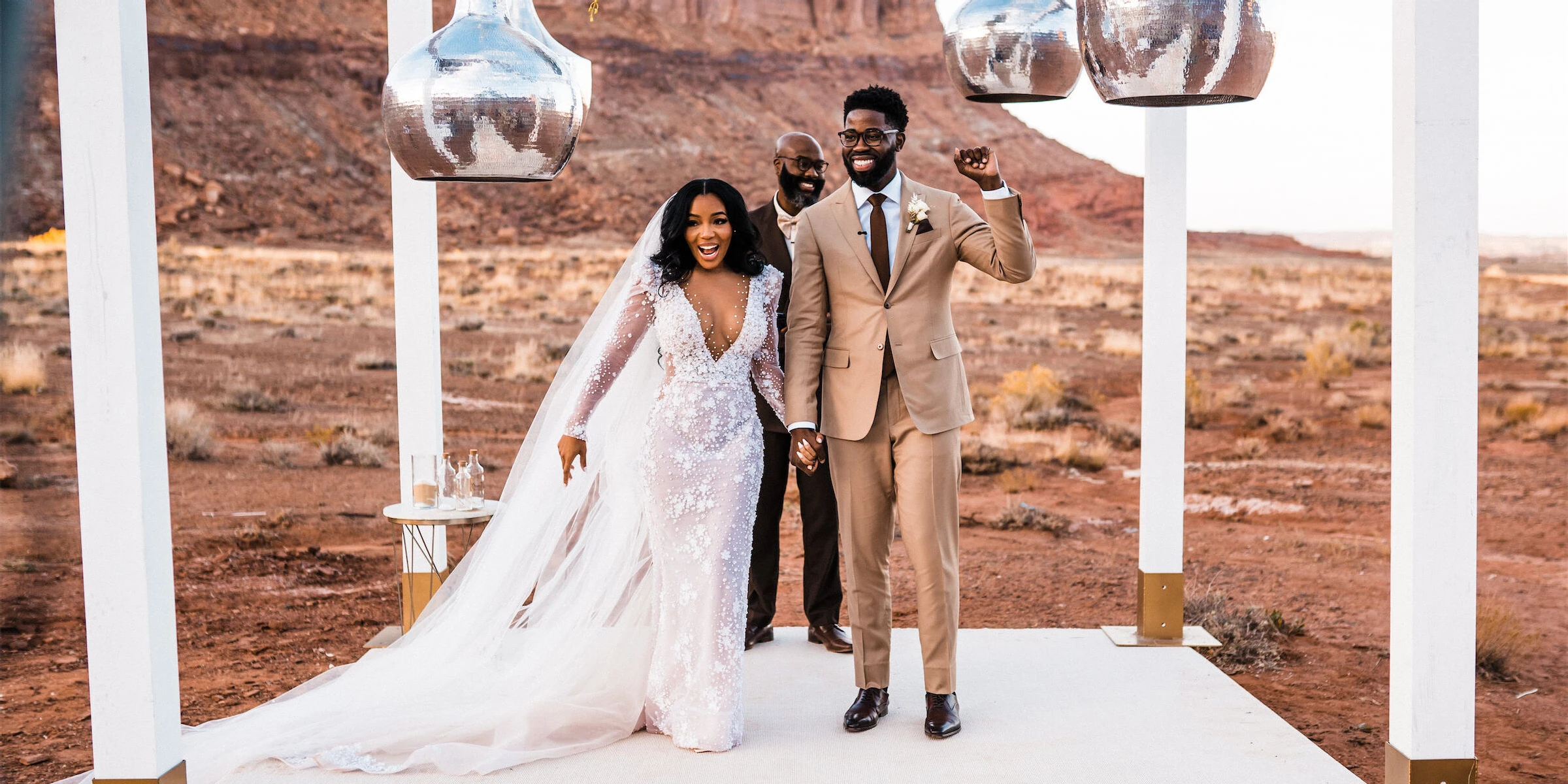 Newlyweds are full of joy at the conclusion of their desert wedding ceremony.