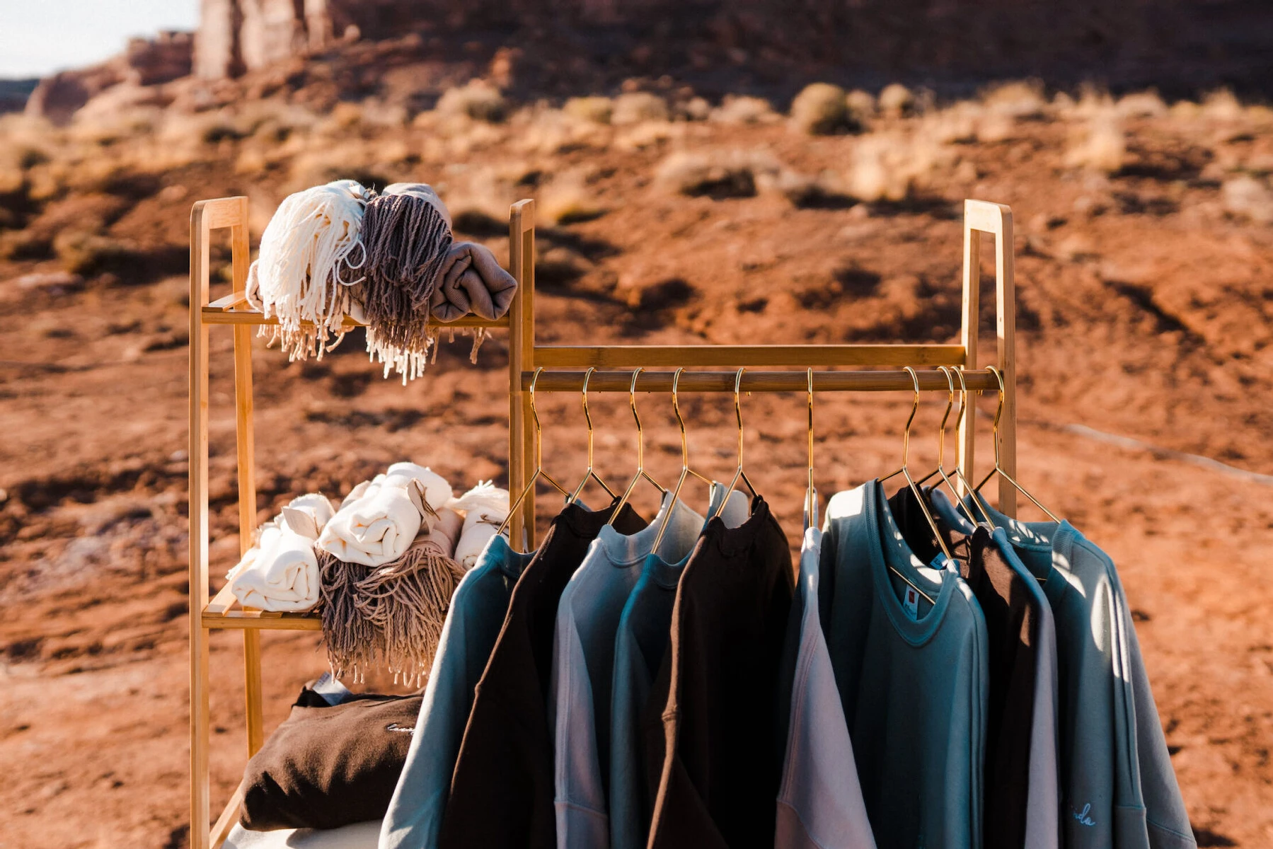 Blankets and custom sweatshirts were set out during cocktail hour of a desert wedding, for guests to grab and stay warm with as the temperatures dropped during the reception.